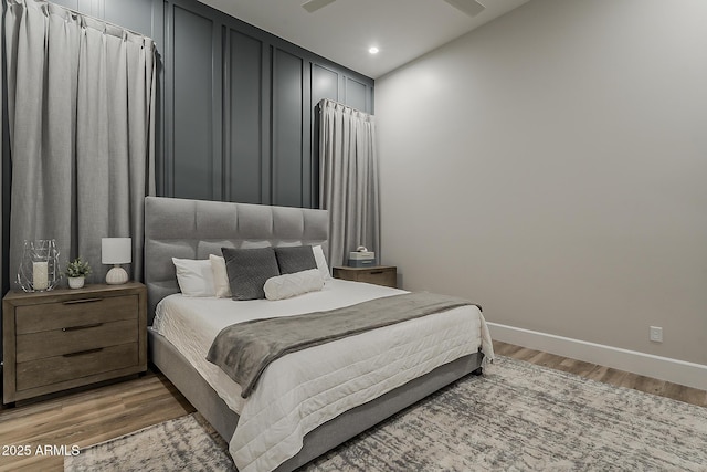 bedroom with baseboards, recessed lighting, and light wood-style flooring