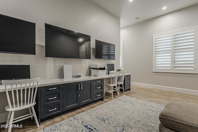 office featuring visible vents, built in study area, baseboards, light wood finished floors, and recessed lighting