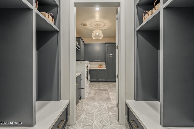 mudroom with washer and dryer, visible vents, and light tile patterned floors
