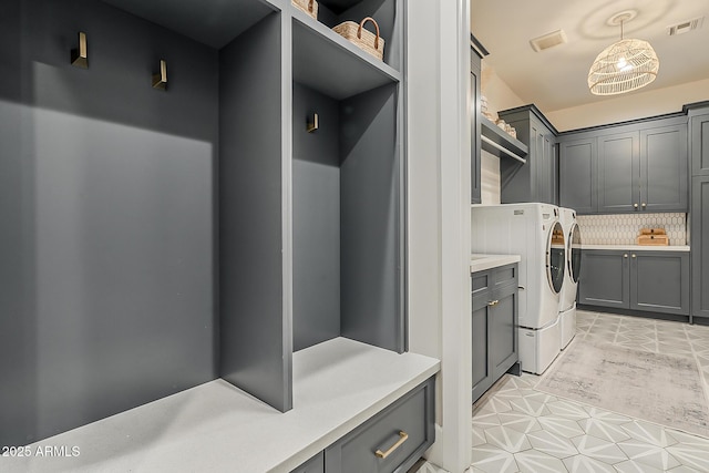 mudroom featuring visible vents and washer and dryer