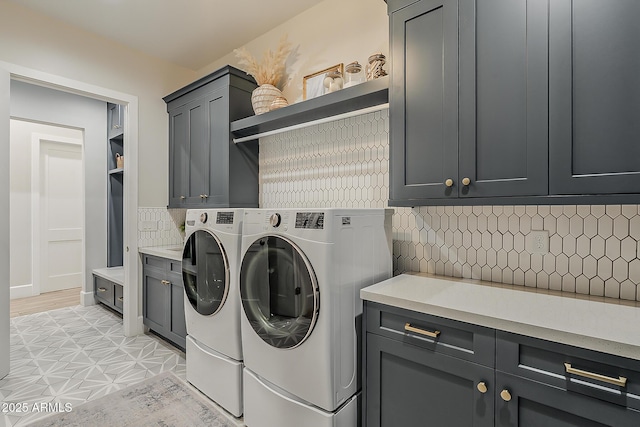 laundry area with cabinet space and washing machine and dryer