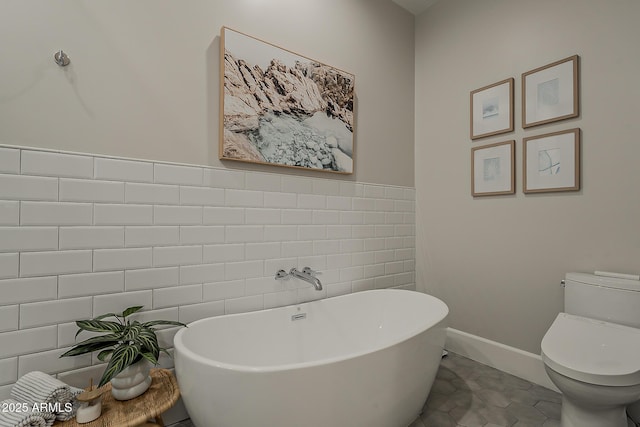 full bathroom featuring tile walls, tile patterned floors, a soaking tub, and toilet