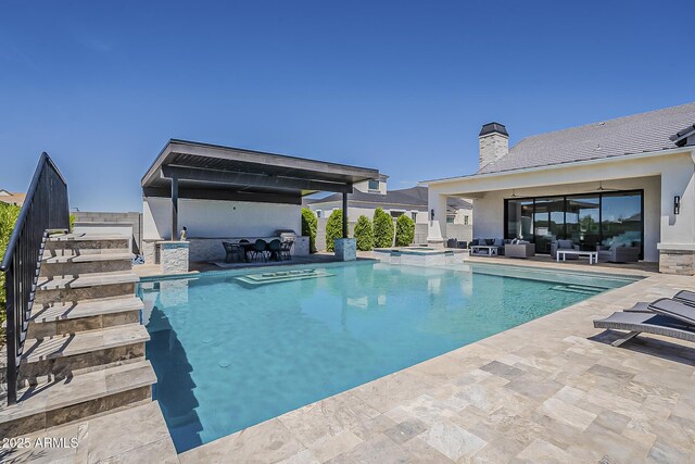 view of swimming pool with an outdoor living space, a patio area, and a pool with connected hot tub