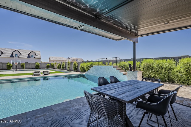 view of swimming pool with stairs, a patio area, fence, a fenced in pool, and outdoor dining space