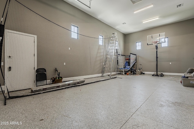 garage featuring baseboards and visible vents