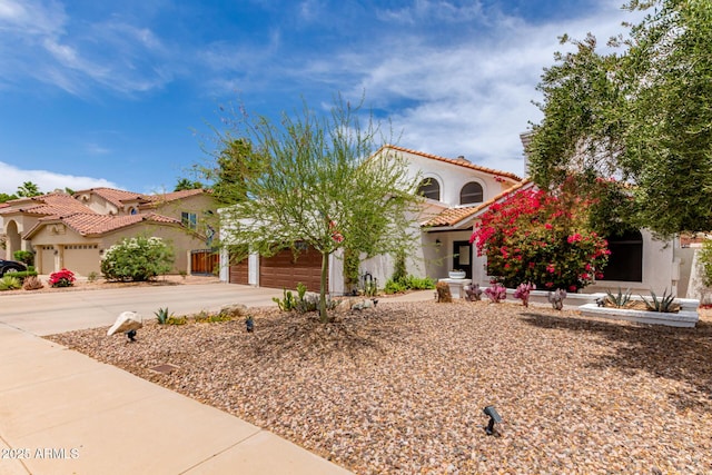 3514 E Desert Willow Rd, Phoenix, AZ 85044 - mediterranean / spanish home with stucco siding, concrete driveway, a tile roof, and a garage