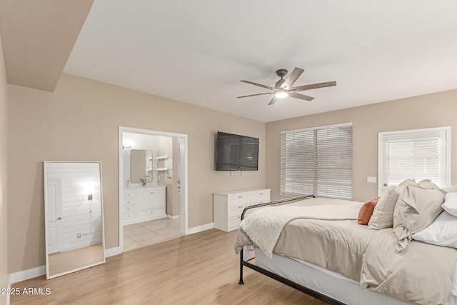 3514 E Desert Willow Rd, Phoenix, AZ 85044 - bedroom featuring light wood-style flooring, baseboards, connected bathroom, and a ceiling fan