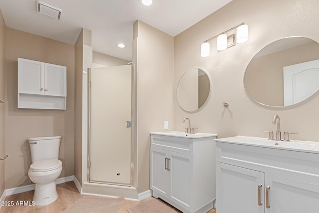 3514 E Desert Willow Rd, Phoenix, AZ 85044 - bathroom featuring a shower stall, two vanities, toilet, baseboards, and recessed lighting