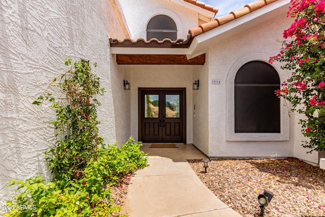 3514 E Desert Willow Rd, Phoenix, AZ 85044 - view of exterior entry featuring stucco siding, french doors, and a tile roof