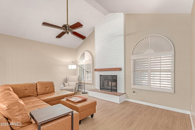 3514 E Desert Willow Rd, Phoenix, AZ 85044 - living area featuring a ceiling fan, a fireplace, wood finished floors, baseboards, and high vaulted ceiling