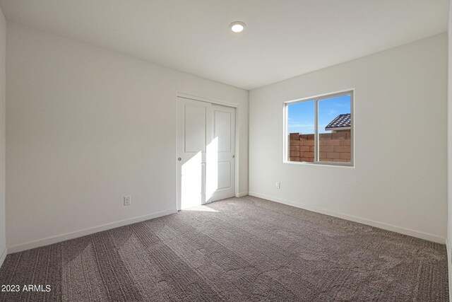 unfurnished bedroom with carpet floors and a closet