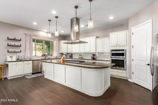 kitchen with island range hood, white cabinets, stainless steel appliances, and a kitchen island