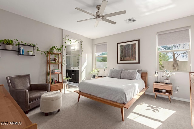 carpeted bedroom with ceiling fan and connected bathroom