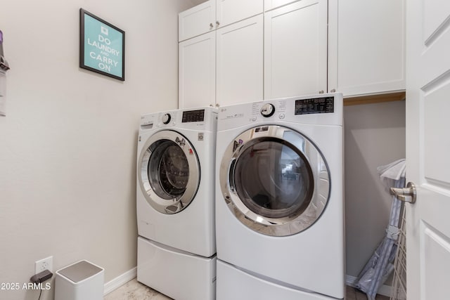 laundry room with cabinets and washer and dryer