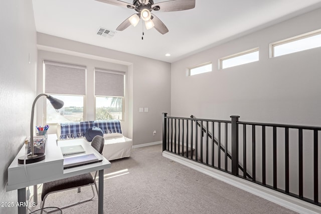 interior space featuring ceiling fan and light colored carpet