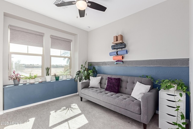 sitting room with carpet and ceiling fan