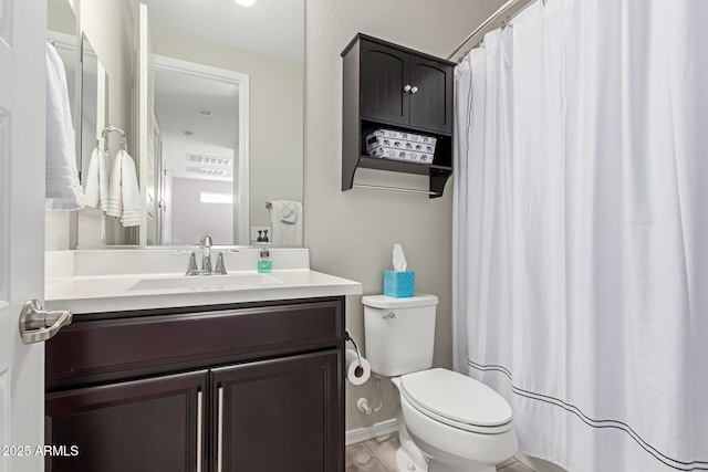 bathroom featuring vanity and toilet