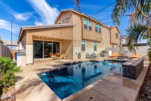 view of swimming pool featuring an outdoor kitchen and a patio area