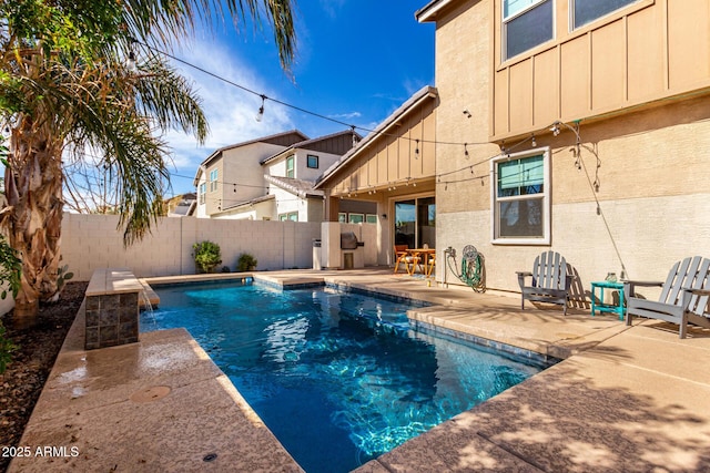 view of swimming pool featuring pool water feature and a patio area