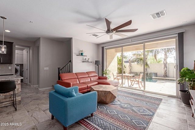 living room with washer / clothes dryer and ceiling fan