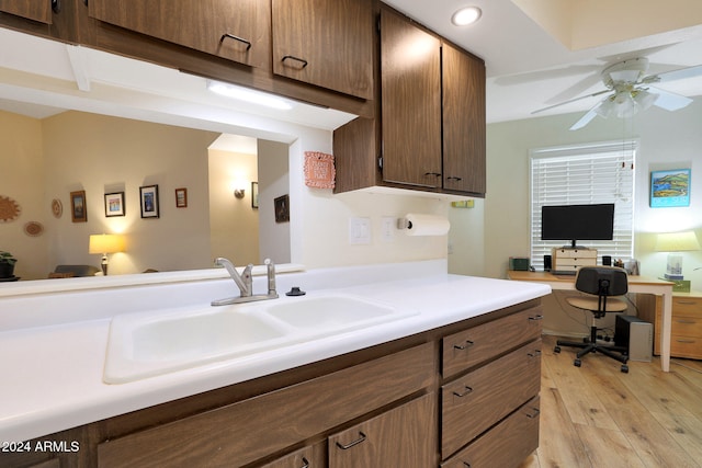 kitchen featuring ceiling fan, built in desk, light hardwood / wood-style floors, and sink