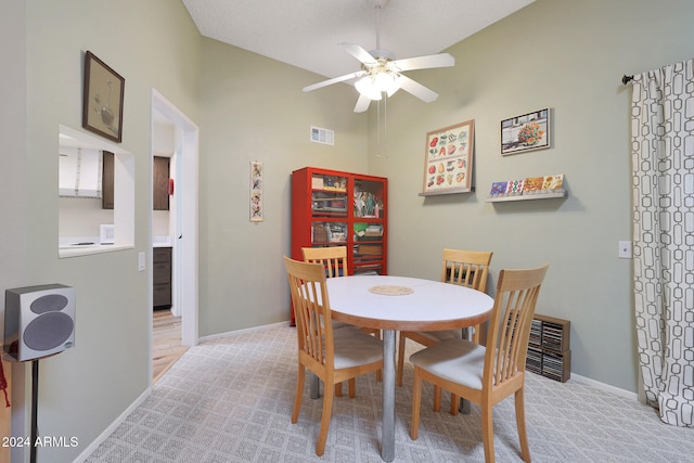 carpeted dining area featuring ceiling fan