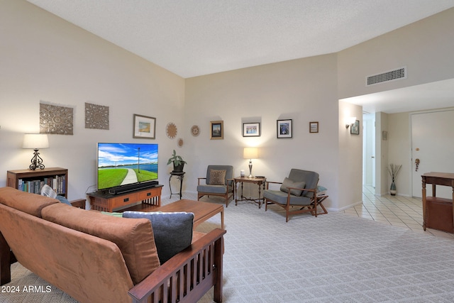 tiled living room featuring a textured ceiling