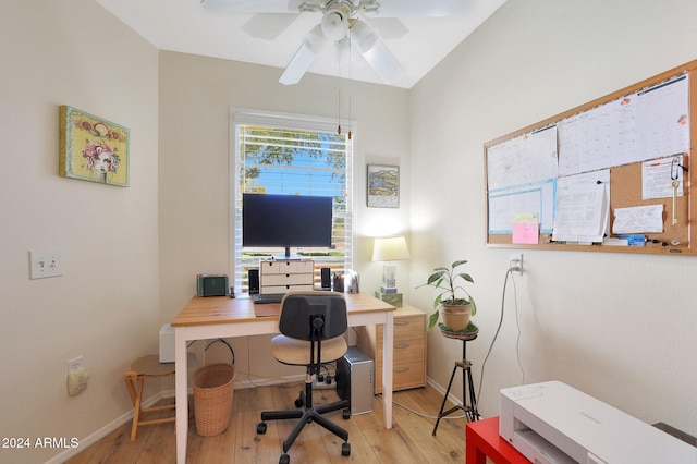 home office with ceiling fan, light hardwood / wood-style floors, and vaulted ceiling