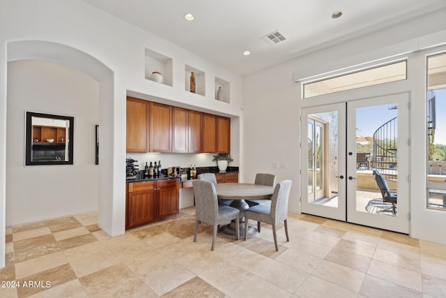 dining space featuring built in features and french doors