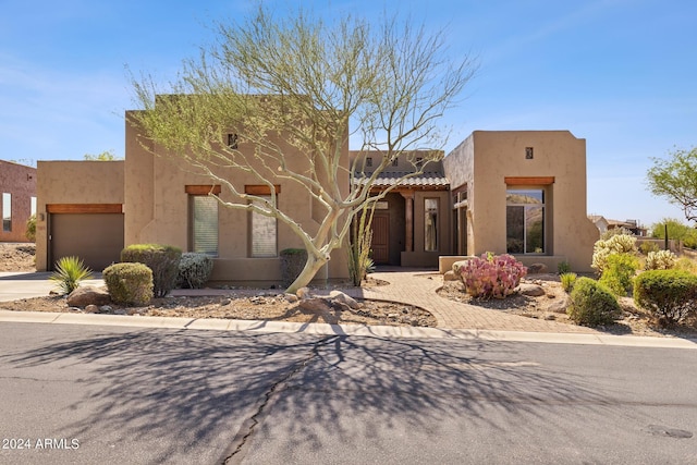 southwest-style home featuring a garage