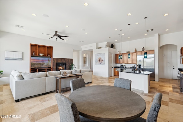 dining area featuring ceiling fan, built in features, and sink