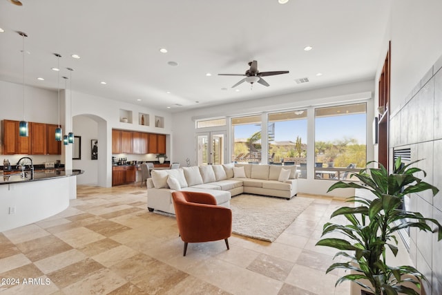 living room with ceiling fan and sink