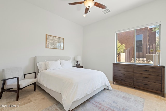 bedroom featuring light tile patterned floors, multiple windows, and ceiling fan