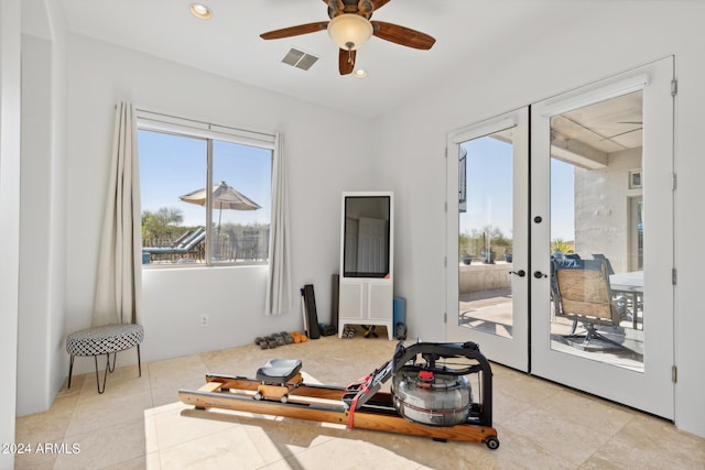 workout room featuring french doors, light tile patterned floors, and ceiling fan