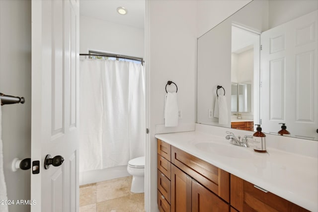 full bathroom with shower / bath combo, vanity, and toilet