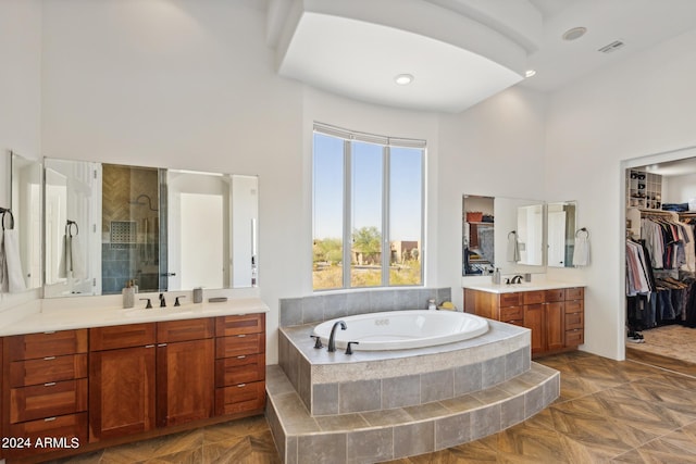 bathroom with vanity, plus walk in shower, parquet flooring, and a high ceiling