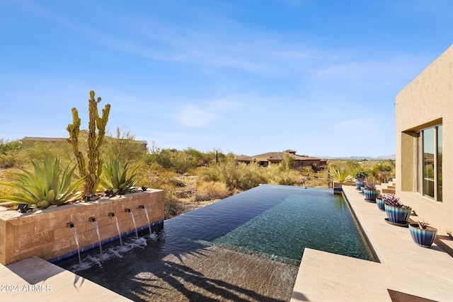 view of pool with pool water feature