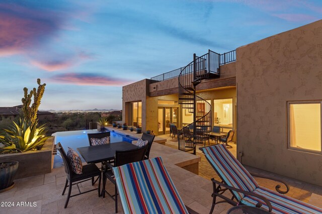 patio terrace at dusk with a balcony