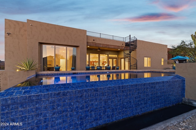 view of pool at dusk