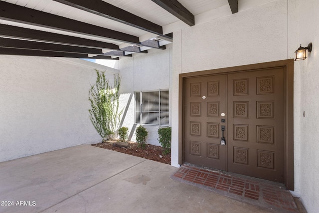 entrance to property featuring a carport