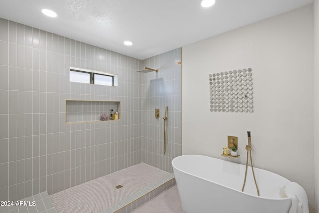 bathroom with separate shower and tub and tile patterned floors