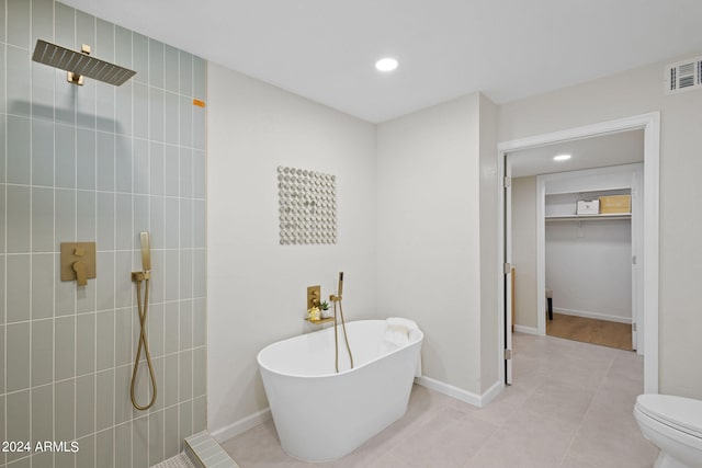 bathroom with tile patterned flooring, plus walk in shower, and toilet