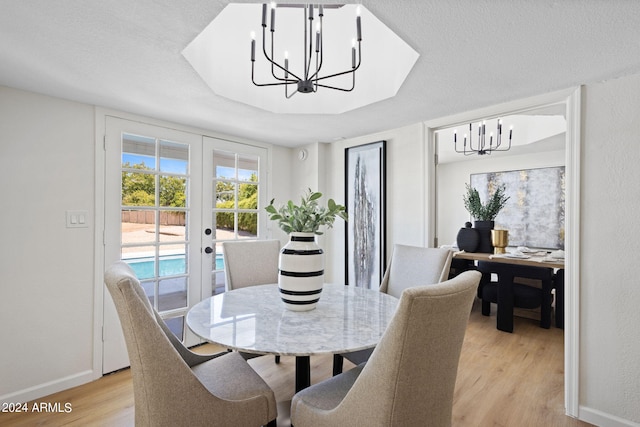 dining area featuring french doors and light wood-type flooring