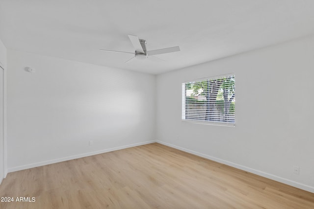 empty room featuring ceiling fan and light wood-type flooring