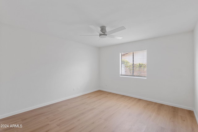 empty room with light hardwood / wood-style floors and ceiling fan