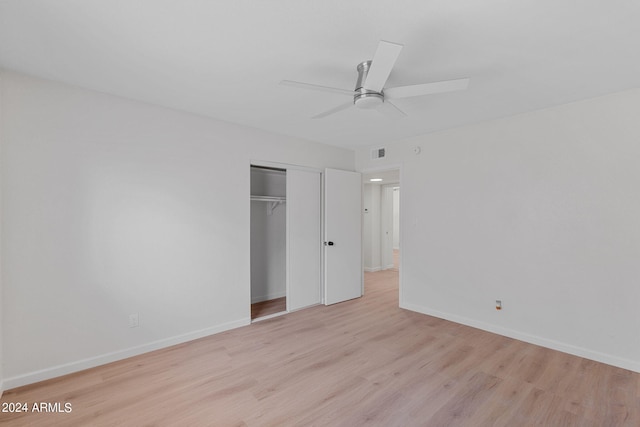 unfurnished bedroom with a closet, light hardwood / wood-style flooring, and ceiling fan