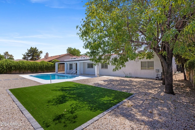 view of swimming pool with a lawn and a patio area