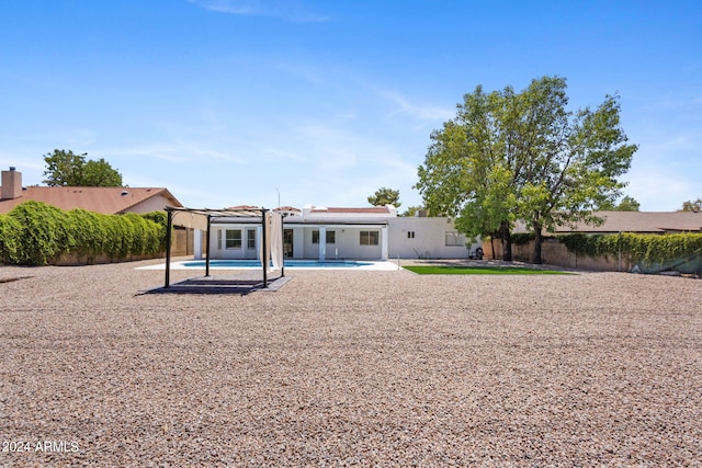 rear view of house featuring a patio and a pergola