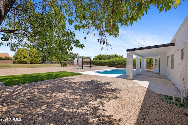 view of pool featuring a patio and a lawn