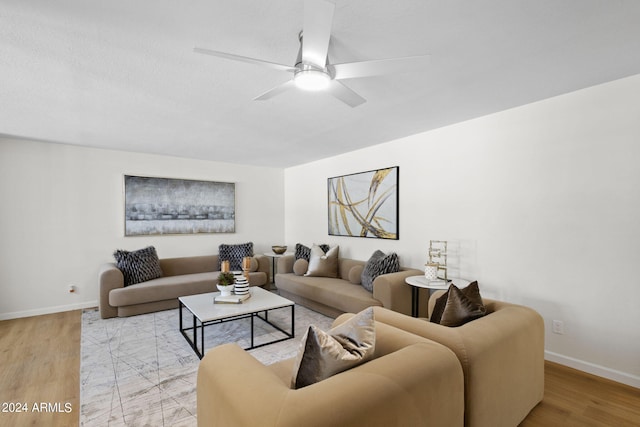 living room featuring light wood-type flooring and ceiling fan